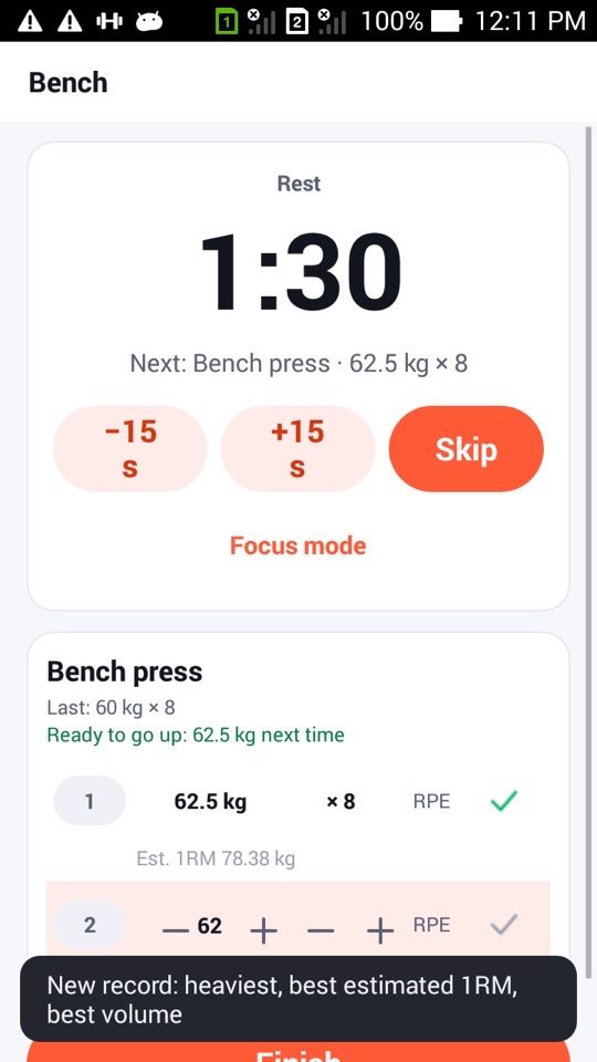 Bench press rest screen with a message at the bottom reading "New record: heaviest, best estimated 1RM, best volume"